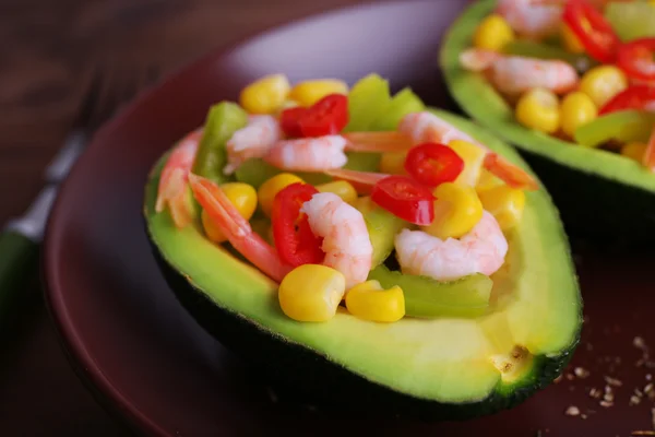 Tasty salad in avocado on plate table close-up — Stock Photo, Image