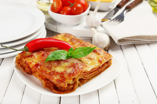 Portion of tasty lasagna on table