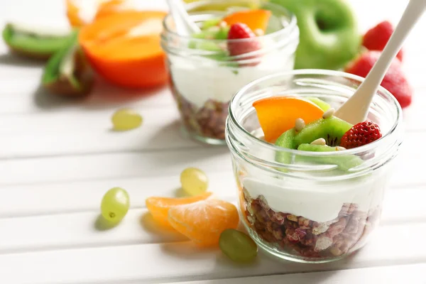 Gezonde dessert met muesli en fruit op tafel — Stockfoto