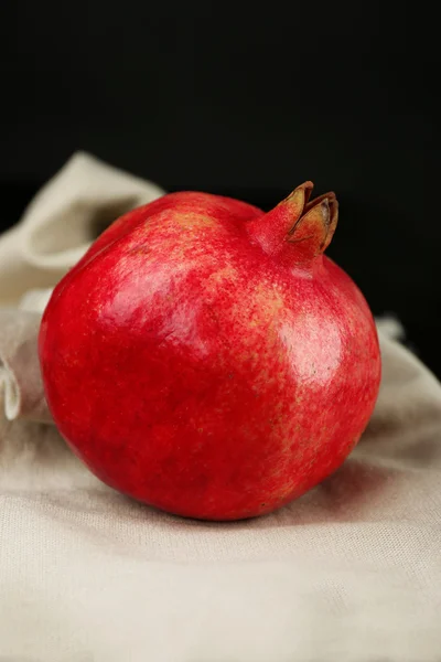 Juicy ripe pomegranates on tablecloth — Stock Photo, Image