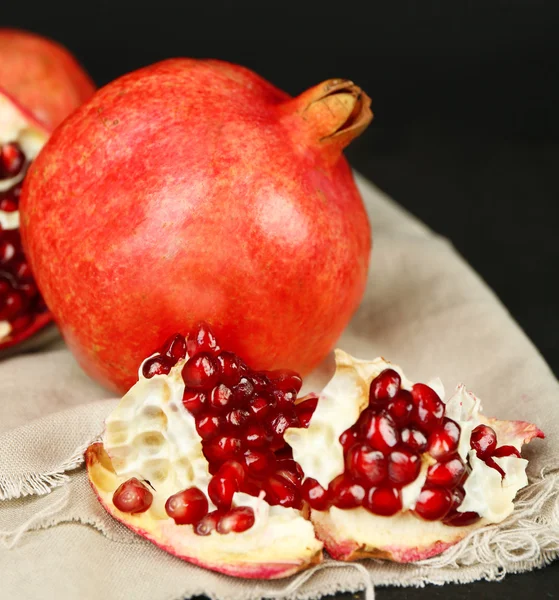 Juicy ripe pomegranates on dark background — Stock Photo, Image