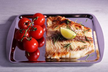 Pangasius fileto biberiye ve metal tepsi ve renk ahşap masa arka plan üzerine kireç ile tabak