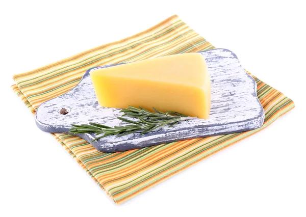 Pedaço de queijo parmesão em tábua de corte de madeira com raminho de alecrim em guardanapo isolado em branco — Fotografia de Stock