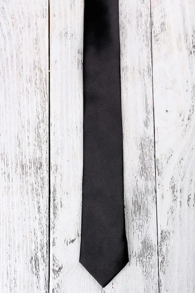 Trendy tie on color wooden background — Stock Photo, Image