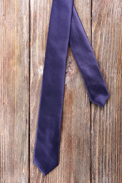 Trendy tie on wooden planks background — Stock Photo, Image