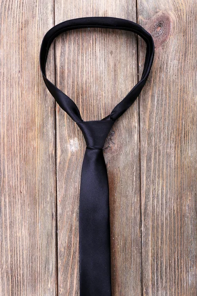 Trendy tie on wooden planks background — Stock Photo, Image