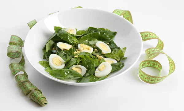 Salad with quail egg and basil in plate isolated on white — Stock Photo, Image