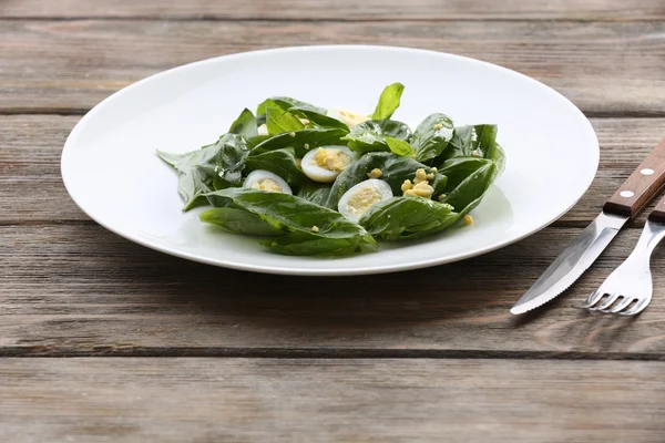 Salad with quail egg and basil in plate on rustic wooden table background — Stock Photo, Image