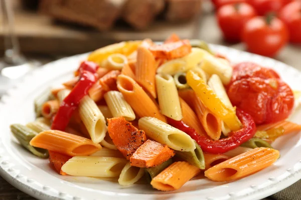 Insalata di pasta con pepe, carota e pomodori su sfondo tavolo di legno — Foto Stock