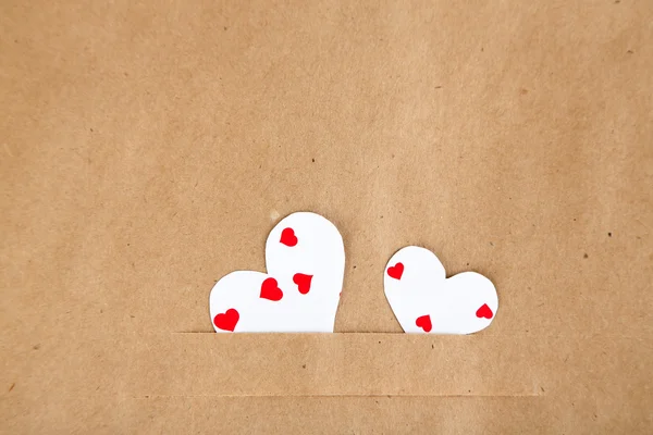 Paper hearts on brown background, close up — Stock Photo, Image