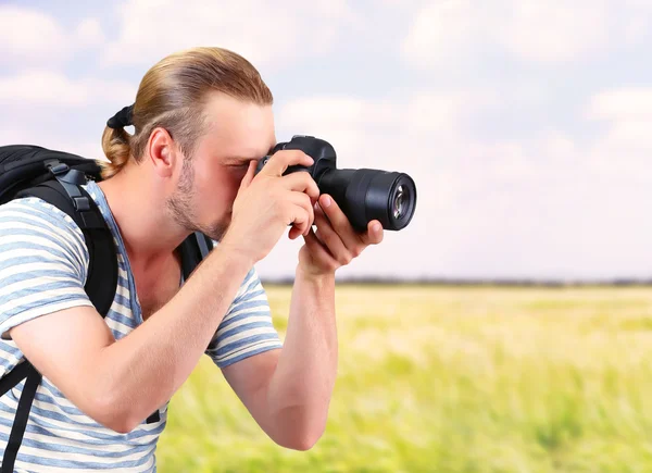 Young photographer taking photos outdoors — Stock Photo, Image