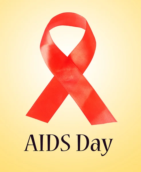 Red AIDS ribbon on light background — Stock Photo, Image