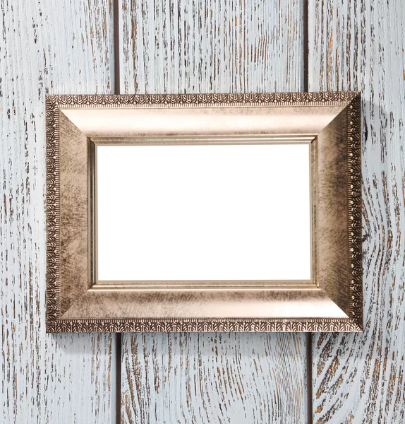 Golden photo frame on color wooden background — Stock Photo, Image