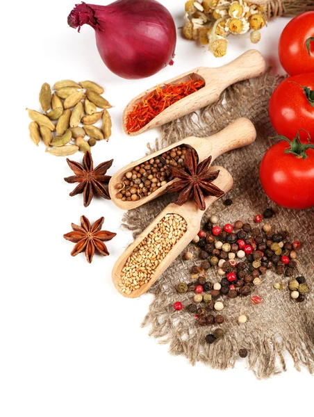 Different spices and herbs in wooden spoons isolated on white — Stock Photo, Image