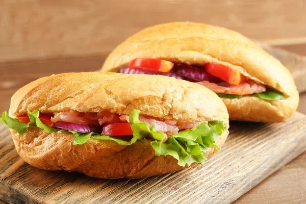 Sandwiches with salmon on wooden background — Stock Photo, Image