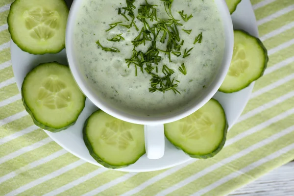 Komkommer soep in kom op een houten tafel achtergrond kleur — Stockfoto