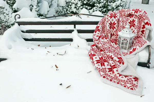 Warmes Plaid auf Bank im Park im Winter — Stockfoto