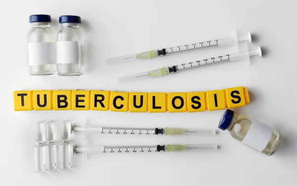 Tuberkulos word och medicinsk utrustning på ljus bakgrund — Stockfoto