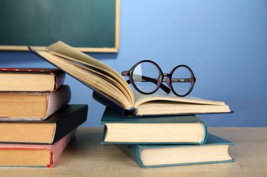 Gözlüklü kitap yığını