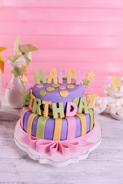 Delicious birthday cake on table on wooden background — Stock Photo, Image