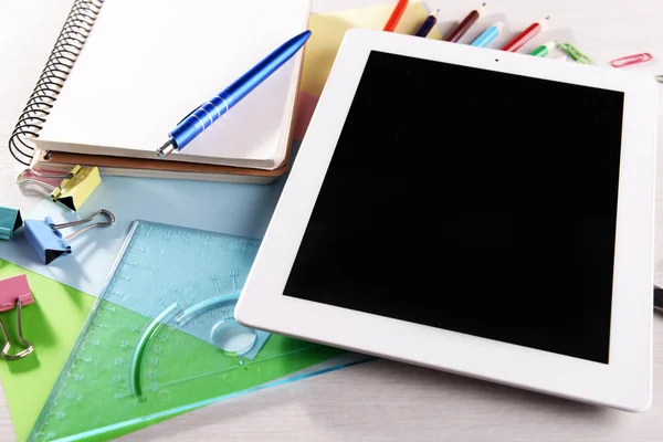 Tablet PC with office supplies on desktop background — Stock Photo, Image