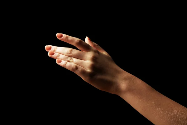 Жіноча рука на темному тлі — стокове фото