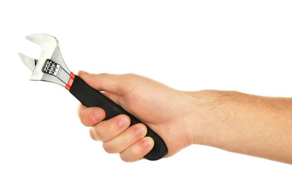 Verstelbare sleutel in mannenhand geïsoleerd op wit — Stockfoto