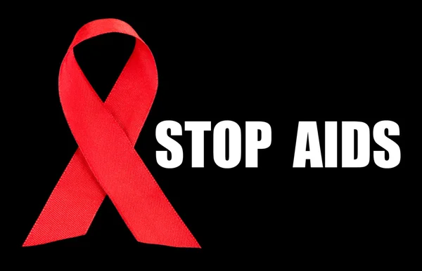 Red AIDS ribbon on black background — Stock Photo, Image