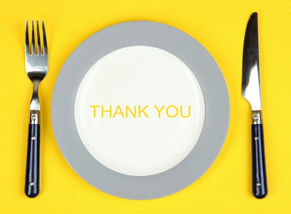 Plate with text Thank You, fork and knife on tablecloth background — Stock Photo, Image