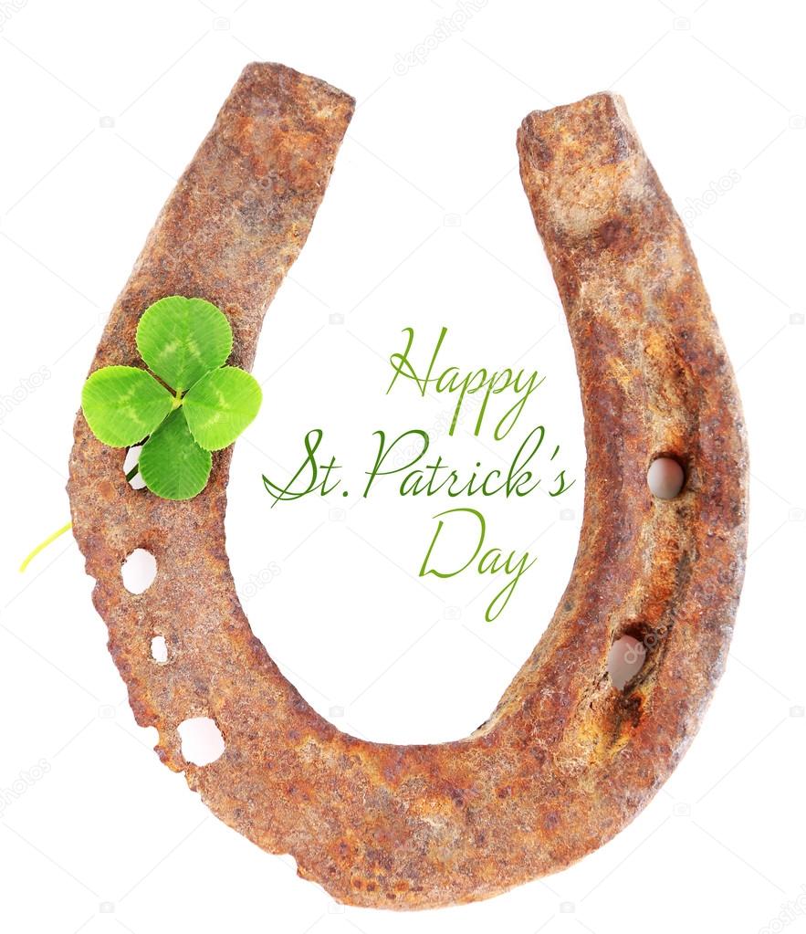 Old horse shoe with clover leaf isolated on white, Happy St.Patrick's Day greeting card