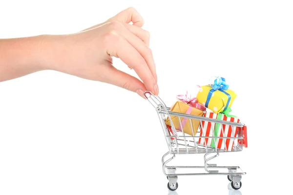 Female hand with small shopping cart full of gifts, isolated on white — Stock Fotó