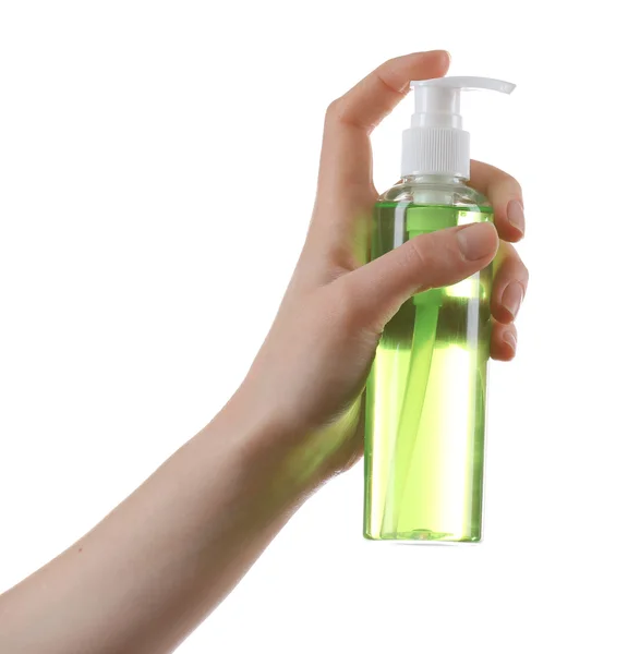 Vrouwelijke hand met cosmetica fles — Stockfoto