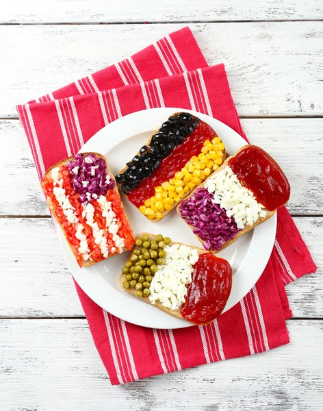 Sandwiches with  different flags on table close-up — Stock Photo, Image