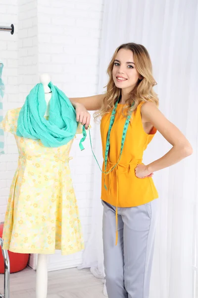 Beautiful young dressmaker in workroom — Stock Photo, Image