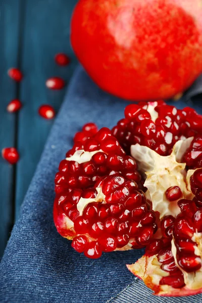 Juicy ripe pomegranates on wooden table — Stock Photo, Image