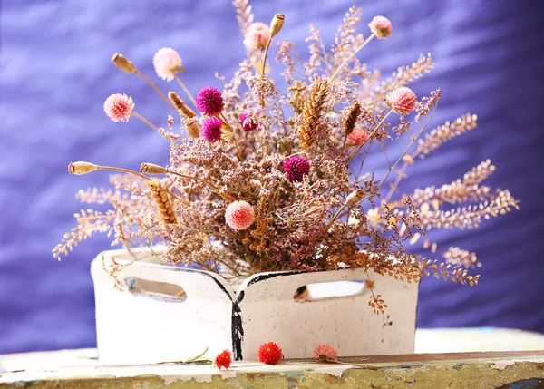 Dried flowers in pot on bright background — Stock Photo, Image