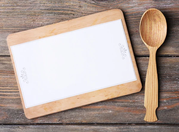 Cutting board with menu sheet of paper on rustic wooden planks background — Stock Photo, Image