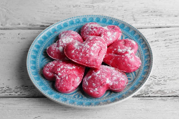 Cookies in form of heart in plate on color wooden table background — Stock Photo, Image