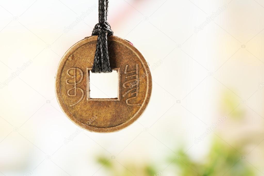 Feng shui coin on light background