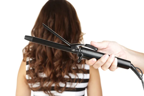 Stylist using curling iron for hair curls, close-up, isolated on white — Stock Photo, Image