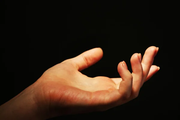 Female hand on dark background — Stock Photo, Image