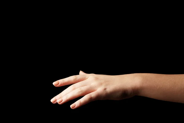 Female hand on dark background — Stock Photo, Image