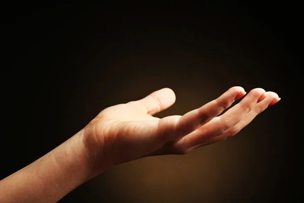 Female hand on dark background — Stock Photo, Image