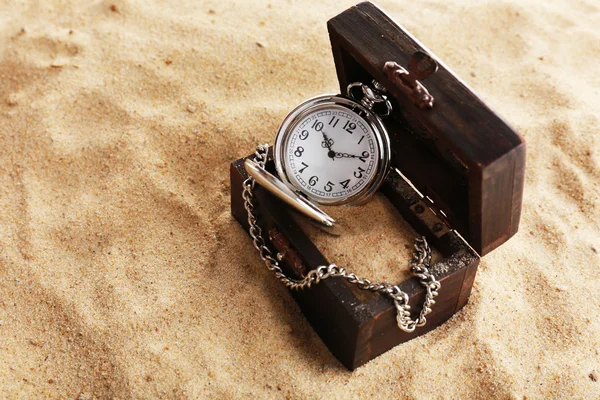 Silver pocket clock on sand background — Stock Photo, Image