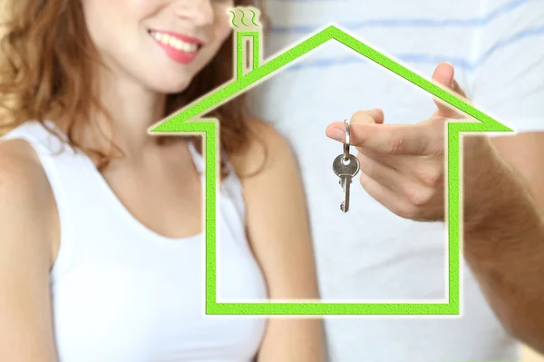 Loving couple with keys in drawing house — Stock Photo, Image