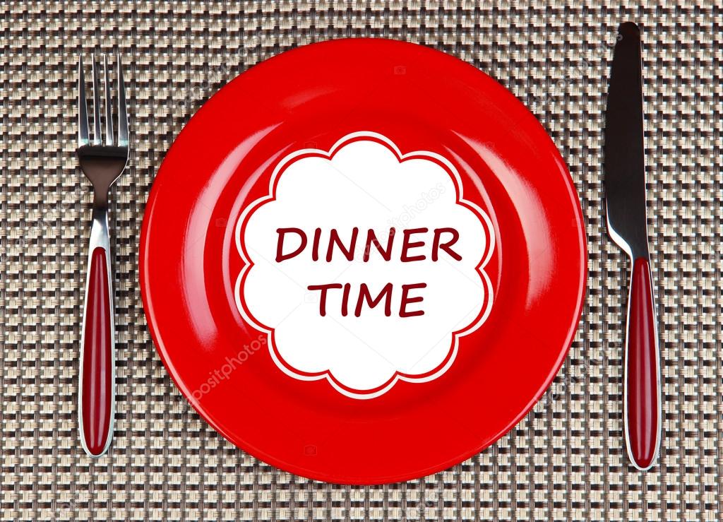 Plate with text Dinner Time, fork and knife on tablecloth background