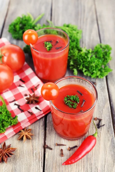 Jus tomat dalam gelas dan sayuran segar di serbet dengan latar belakang kayu — Stok Foto