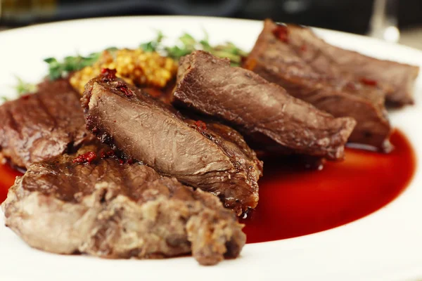 Steak on plate on table — Stock Photo, Image