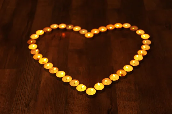 Burning candles in shape of heart — Stock Photo, Image