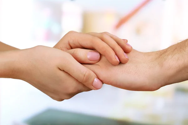 Male and female hands on light background — Stock Photo, Image